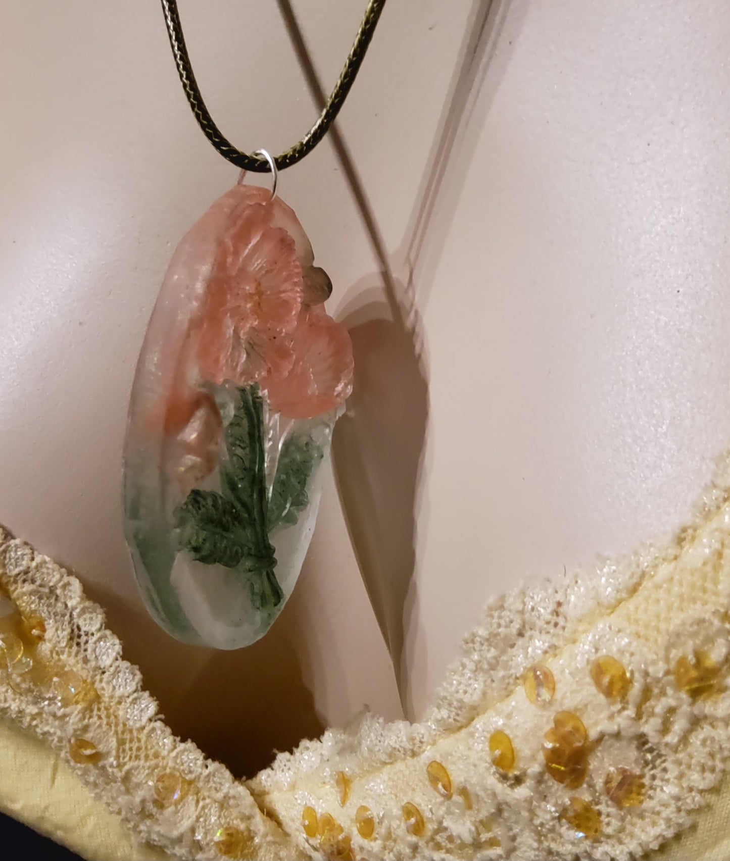 3D resin oval necklace peach blossom green worn on mannequin