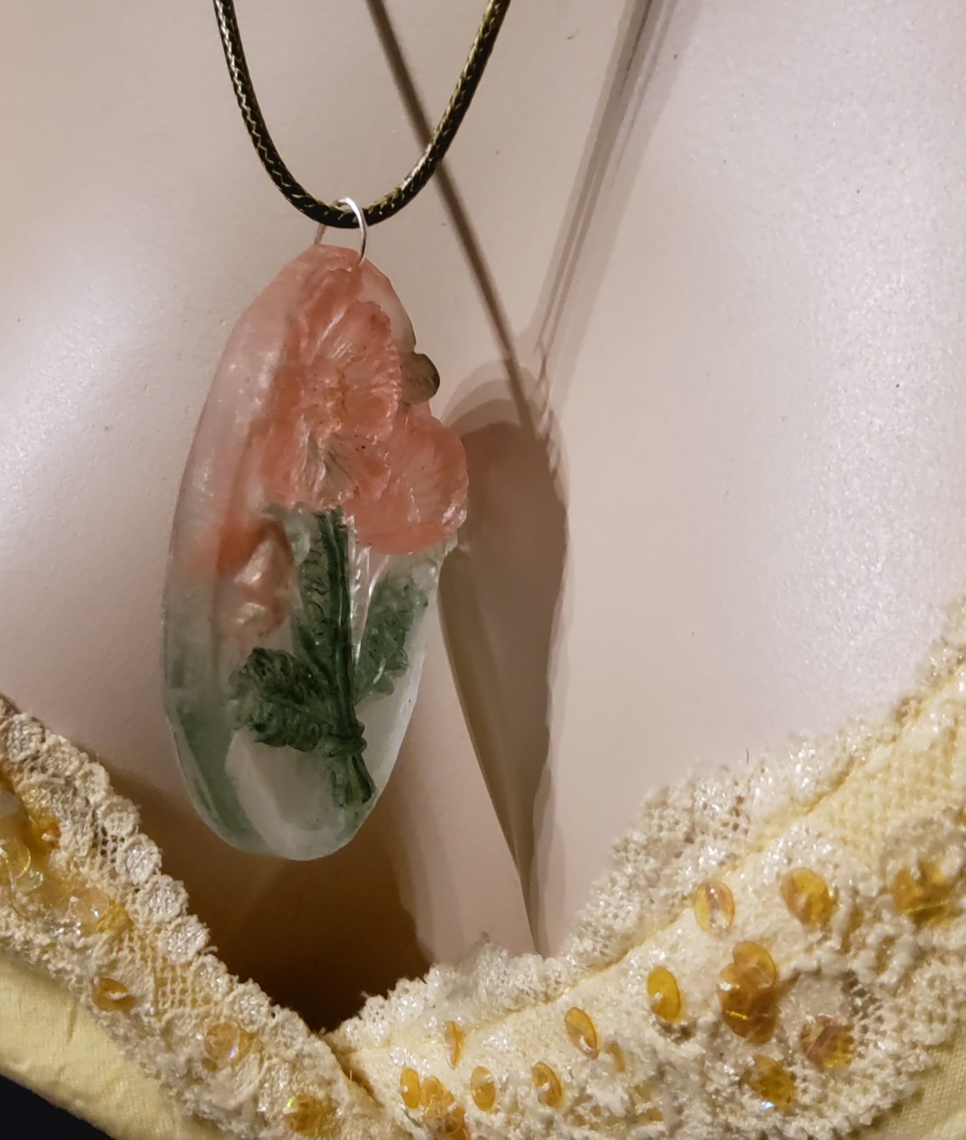 3D resin oval necklace peach blossom green worn on mannequin